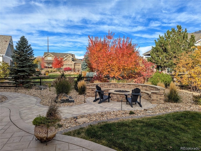 exterior space with a fire pit, a patio area, and fence