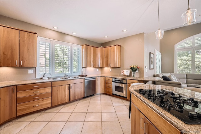 6961 Salvia St, Arvada, CO 80007 - kitchen with appliances with stainless steel finishes, recessed lighting, light tile patterned flooring, hanging light fixtures, and open floor plan