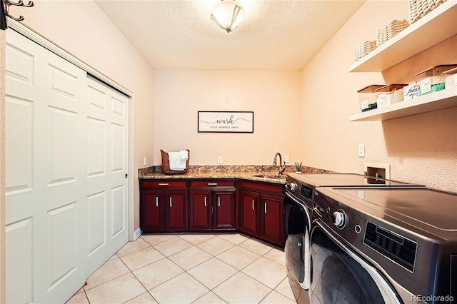 6961 Salvia St, Arvada, CO 80007 - washroom featuring washing machine and dryer, cabinet space, a textured ceiling, and light tile patterned floors