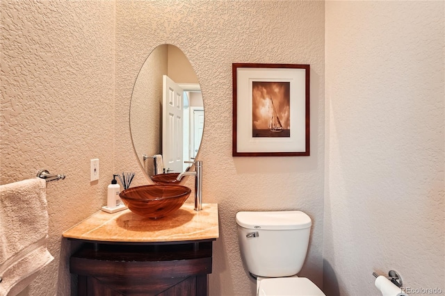 6961 Salvia St, Arvada, CO 80007 - bathroom with vanity and a textured wall