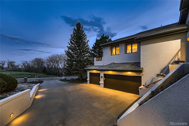 6961 Salvia St, Arvada, CO 80007 - view of side of property featuring a garage, driveway, and stucco siding