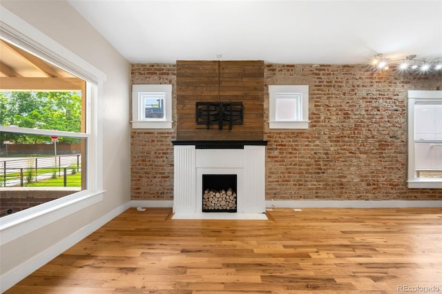 1753 W 36th Ave, Denver, CO 80211 - unfurnished living room featuring wood finished floors and a large fireplace
