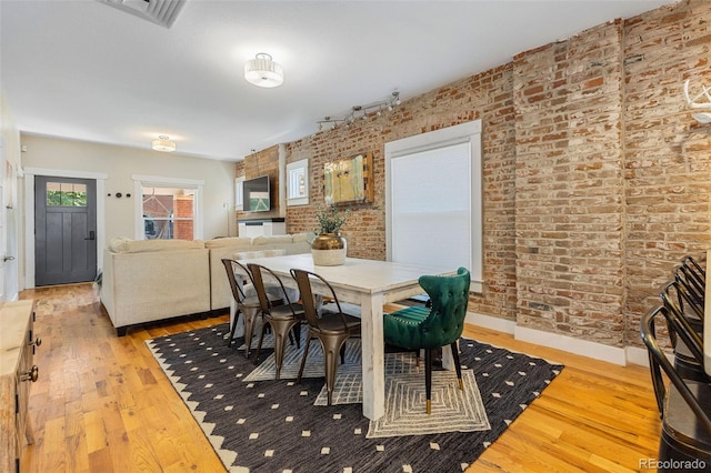 1753 W 36th Ave, Denver, CO 80211 - dining area featuring brick wall and wood finished floors