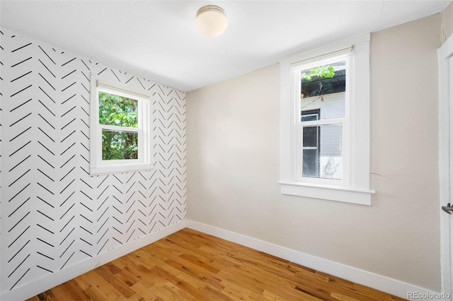 1753 W 36th Ave, Denver, CO 80211 - empty room featuring light wood-style flooring and an accent wall