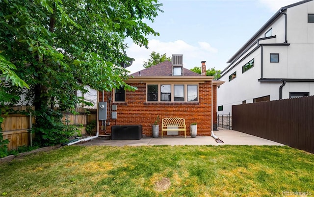 1753 W 36th Ave, Denver, CO 80211 - rear view of house featuring brick siding, a fenced backyard, a patio, and a chimney