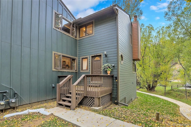 4863 Silver Spruce Ln, Evergreen, CO 80439 - back of house featuring a chimney and board and batten siding