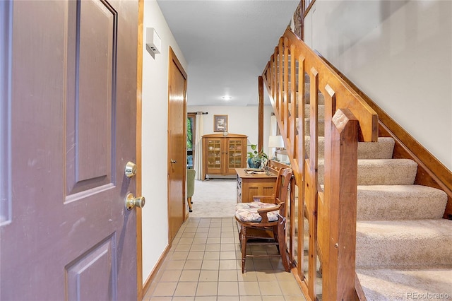 4863 Silver Spruce Ln, Evergreen, CO 80439 - foyer entrance featuring stairway, light tile patterned flooring, light colored carpet, and baseboards