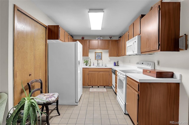 4863 Silver Spruce Ln, Evergreen, CO 80439 - kitchen with white appliances, light countertops, light tile patterned floors, a sink, and brown cabinetry