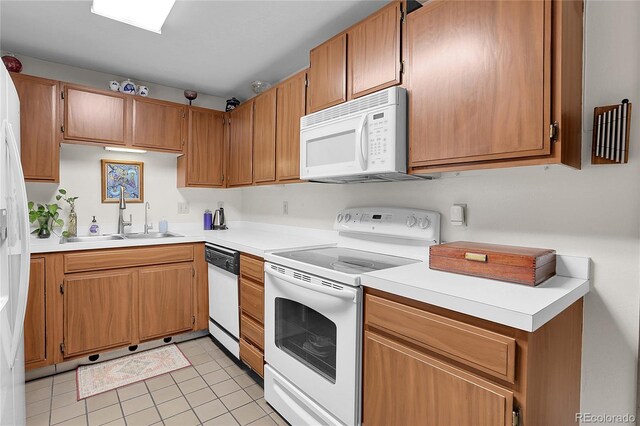 4863 Silver Spruce Ln, Evergreen, CO 80439 - kitchen featuring white appliances, a sink, light countertops, light tile patterned floors, and brown cabinets