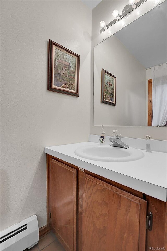 4863 Silver Spruce Ln, Evergreen, CO 80439 - bathroom with a baseboard radiator, vanity, and tile patterned flooring