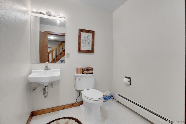 4863 Silver Spruce Ln, Evergreen, CO 80439 - half bath featuring a baseboard heating unit, toilet, and baseboards