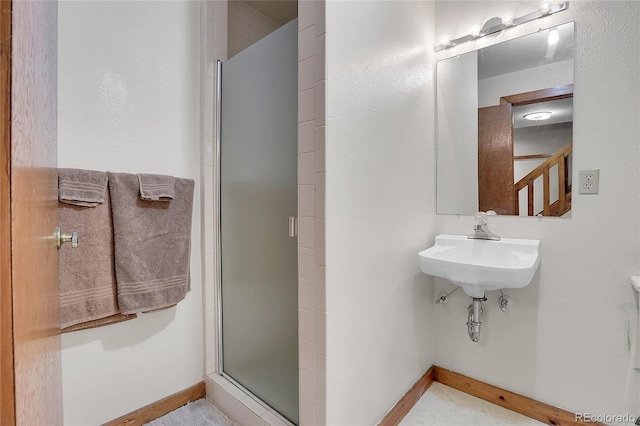 4863 Silver Spruce Ln, Evergreen, CO 80439 - bathroom with a stall shower, baseboards, and a sink