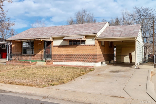 ranch-style home featuring a carport and a front yard