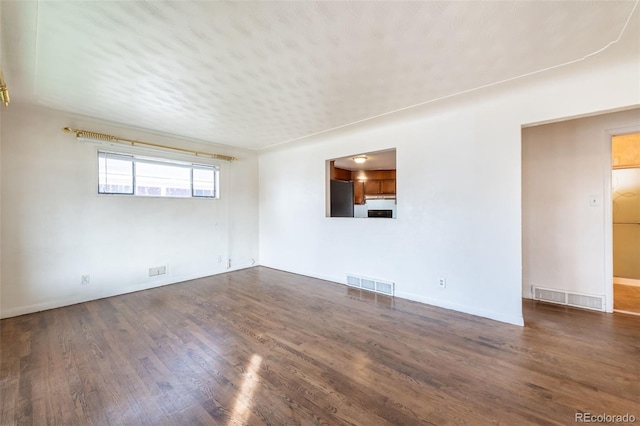 spare room with dark hardwood / wood-style flooring