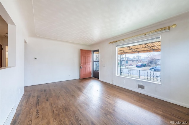 empty room featuring dark hardwood / wood-style flooring