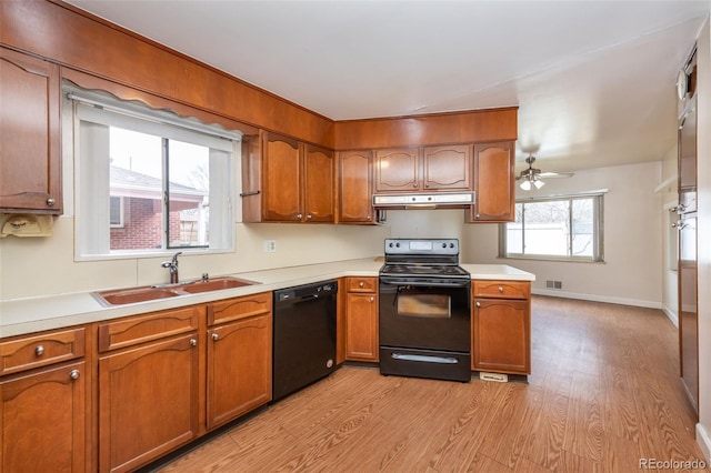 kitchen featuring sink, light hardwood / wood-style flooring, ceiling fan, and black appliances