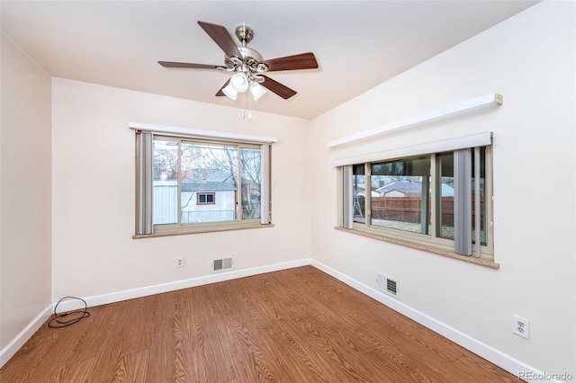 empty room featuring ceiling fan and hardwood / wood-style flooring