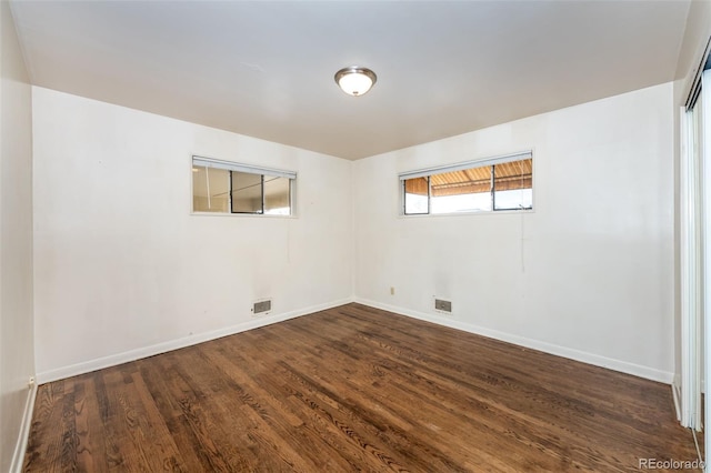 basement with dark hardwood / wood-style floors