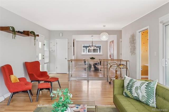 260 S Jasmine St, Denver, CO 80224 - living area featuring wood finished floors, a chandelier, and baseboards