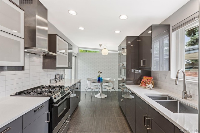 260 S Jasmine St, Denver, CO 80224 - kitchen featuring appliances with stainless steel finishes, a sink, wall chimney range hood, plenty of natural light, and recessed lighting