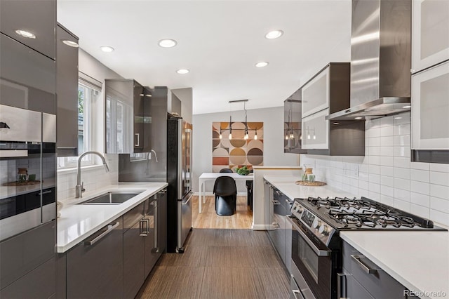 260 S Jasmine St, Denver, CO 80224 - kitchen with appliances with stainless steel finishes, wall chimney range hood, a sink, recessed lighting, and light countertops