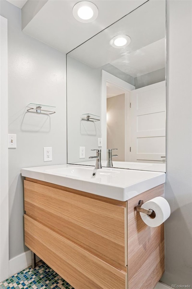 260 S Jasmine St, Denver, CO 80224 - bathroom with vanity, baseboards, and tile patterned flooring