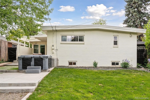 260 S Jasmine St, Denver, CO 80224 - rear view of house featuring a hot tub, a patio area, and brick siding