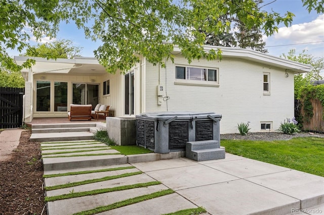 260 S Jasmine St, Denver, CO 80224 - back of house featuring brick siding, a patio, and a hot tub