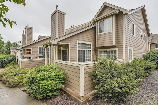 6839 Zenobia St Unit 3, Westminster, CO 80030 - view of side of home featuring a chimney