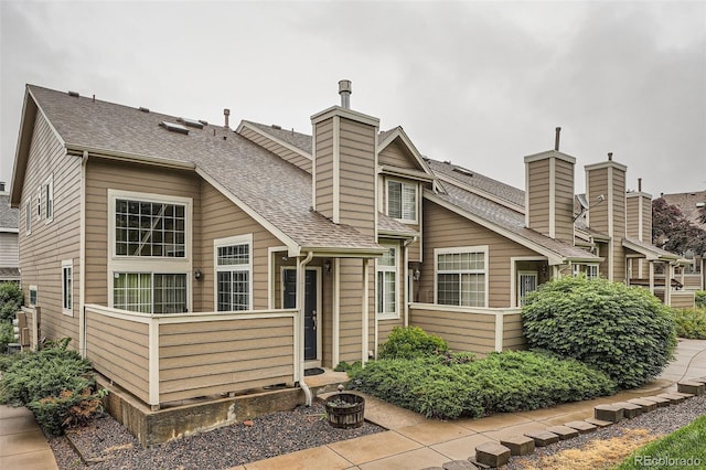 6839 Zenobia St Unit 3, Westminster, CO 80030 - rear view of house with a chimney and a shingled roof