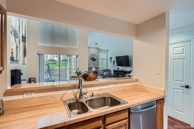 6839 Zenobia St Unit 3, Westminster, CO 80030 - kitchen featuring stainless steel dishwasher, a sink, wooden counters, wood finished floors, and open floor plan