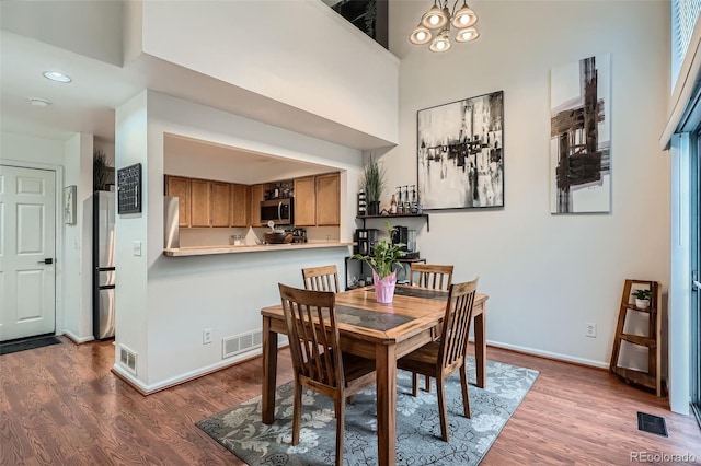6839 Zenobia St Unit 3, Westminster, CO 80030 - dining area with wood finished floors, a high ceiling, baseboards, and recessed lighting