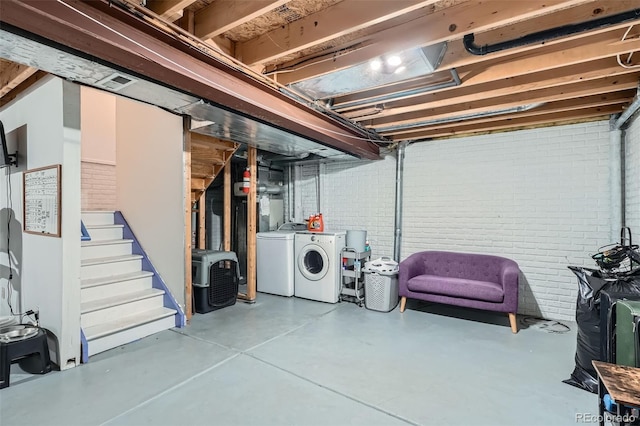 6839 Zenobia St Unit 3, Westminster, CO 80030 - unfinished below grade area featuring independent washer and dryer, brick wall, and stairway