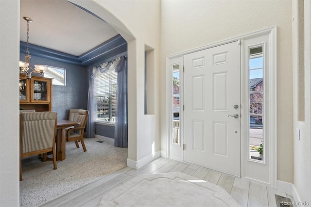 foyer entrance featuring an inviting chandelier