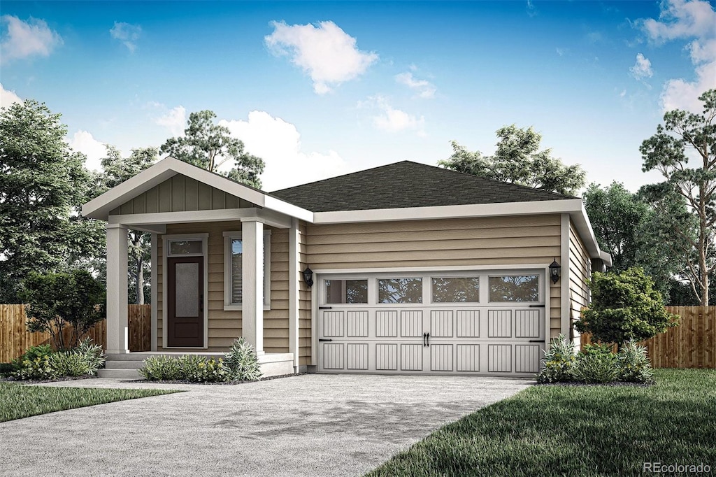 view of front of house featuring a garage and a front lawn