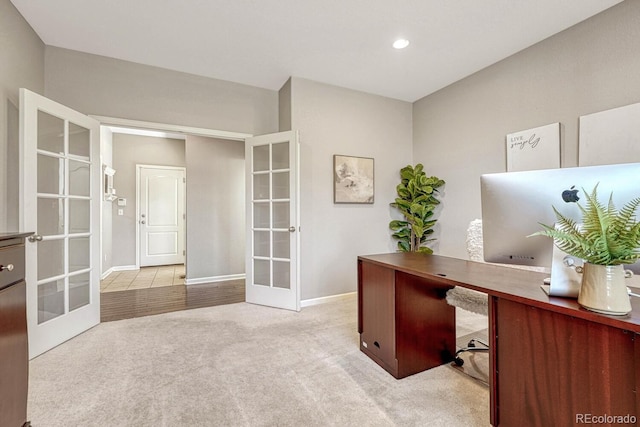 unfurnished office featuring french doors and light carpet