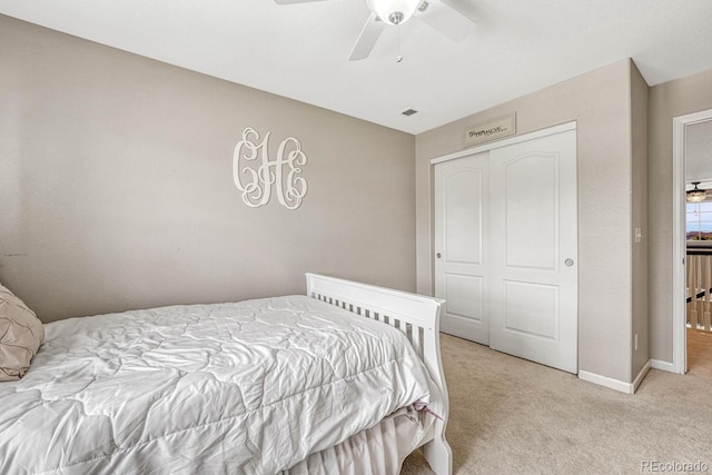 carpeted bedroom featuring a closet and ceiling fan