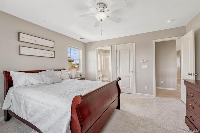 bedroom featuring connected bathroom, light colored carpet, and ceiling fan