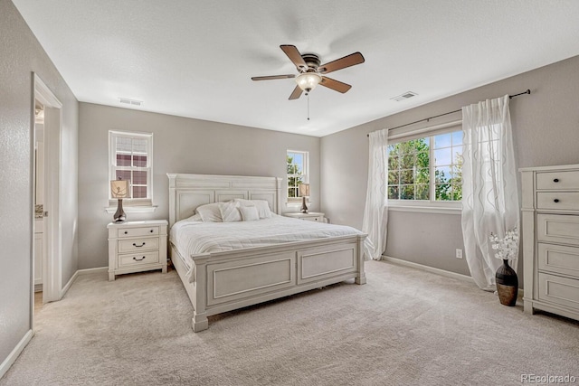 bedroom with light carpet and ceiling fan