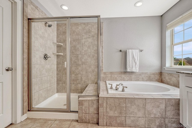 bathroom featuring tile patterned flooring and plus walk in shower