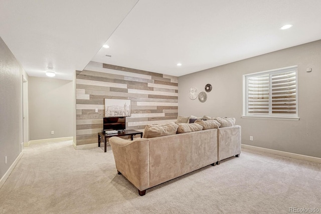 living room with light carpet and wood walls