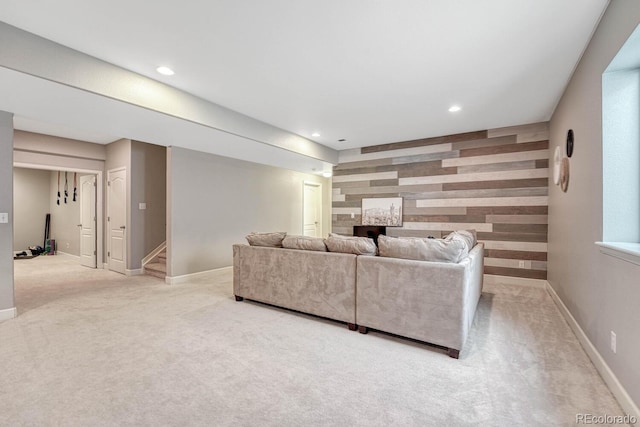 living room with light colored carpet and wood walls