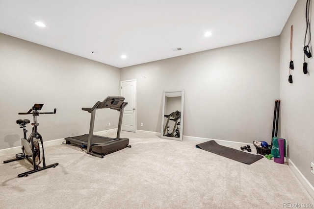 exercise room with light colored carpet