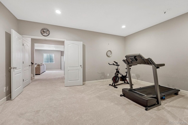 exercise room featuring light colored carpet