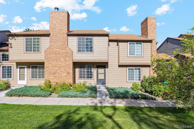 892 Summer Dr Unit 15B, Highlands Ranch, CO 80126 - view of front facade with a chimney and a front lawn