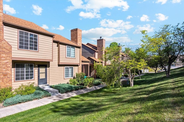 892 Summer Dr Unit 15B, Highlands Ranch, CO 80126 - back of house featuring a yard and a chimney