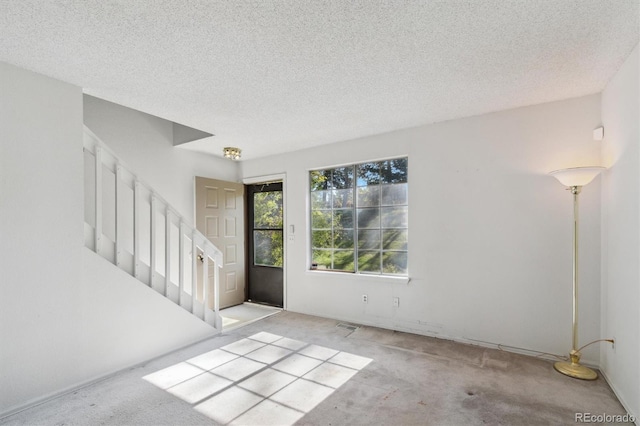 892 Summer Dr Unit 15B, Highlands Ranch, CO 80126 - carpeted entrance foyer with stairs and a textured ceiling