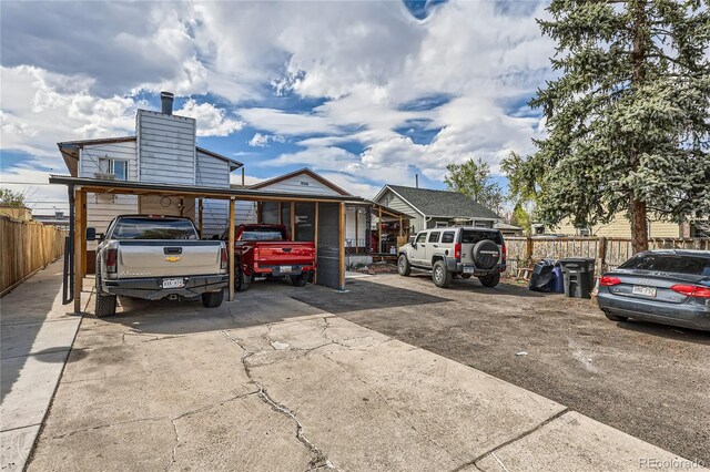 655 S Perry St, Denver, CO 80219 - view of parking / parking lot with fence and concrete driveway