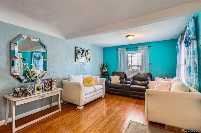 655 S Perry St, Denver, CO 80219 - living room with a textured wall, wood-type flooring, a textured ceiling, and baseboards