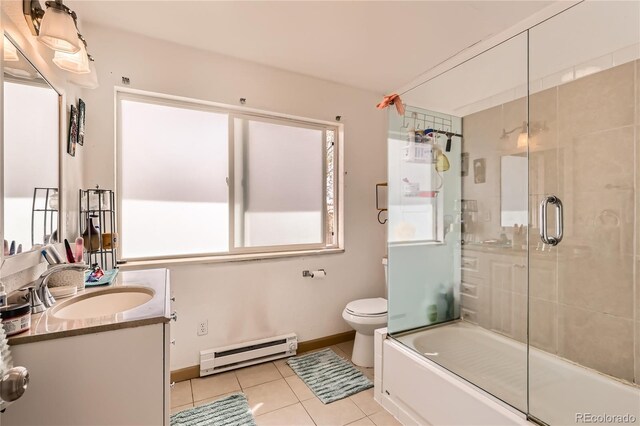 655 S Perry St, Denver, CO 80219 - bathroom featuring vanity, baseboards, tile patterned flooring, toilet, and a baseboard radiator
